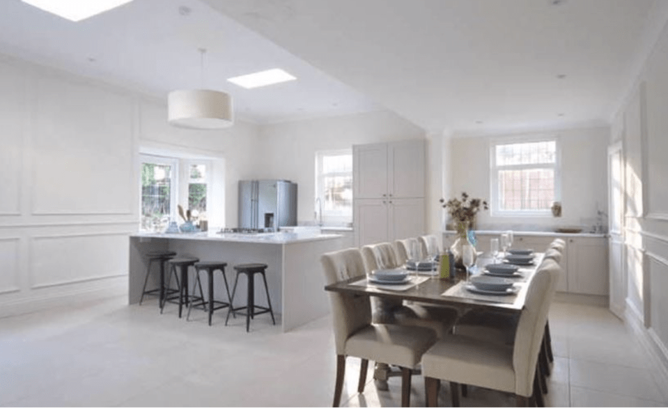  There is a plush kitchen with island and stools