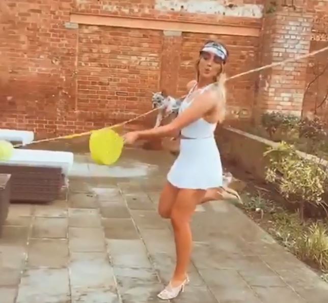  Perrie played a game of swing ball with her pooch in the video