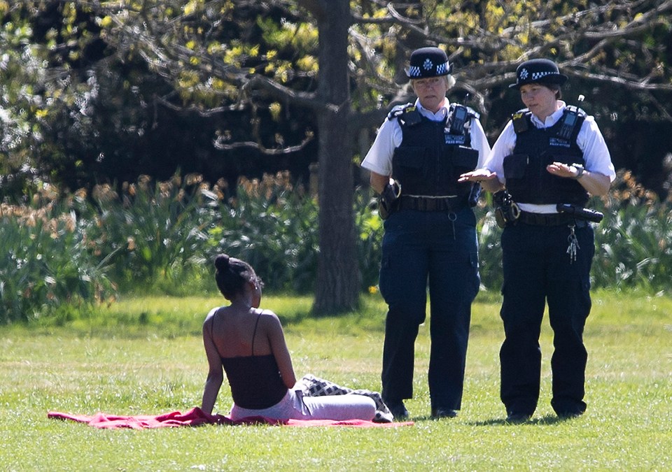  Police speaking to a sunbather ignoring social distancing