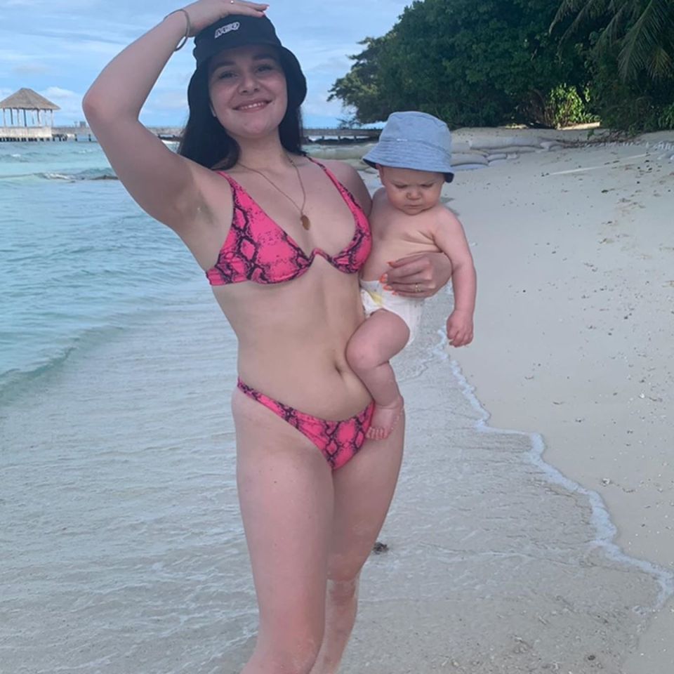 Pictured with baby Oscar on the beach