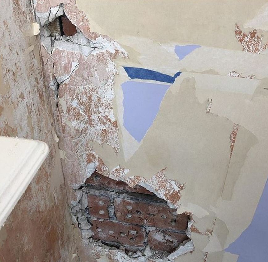  Whilst trying to remove some old wallpaper, this disastrous home improver ended up removing more than she planned - a far cry from the trendy exposed brick that you'd see on the likes of Grand Designs