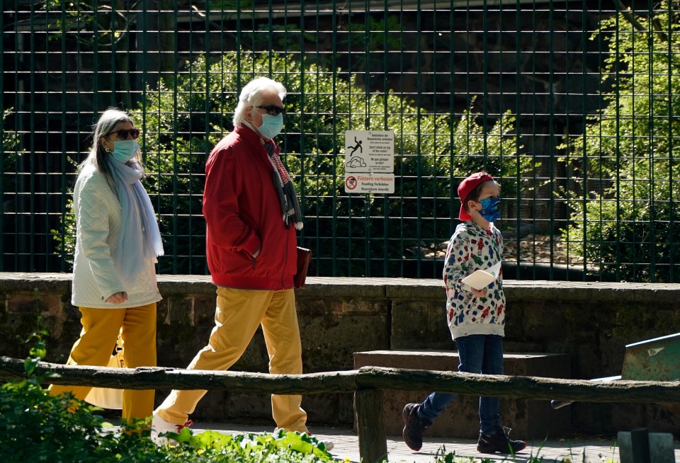  Visitors wear protective face masks at a zoo in Landau, Germany