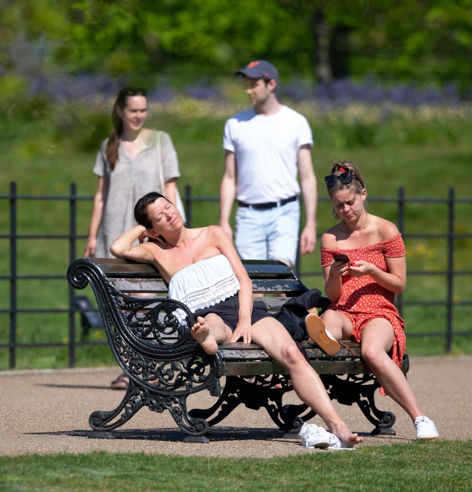  Two women were seen enjoying the sunshine in Kensington Gardens in London