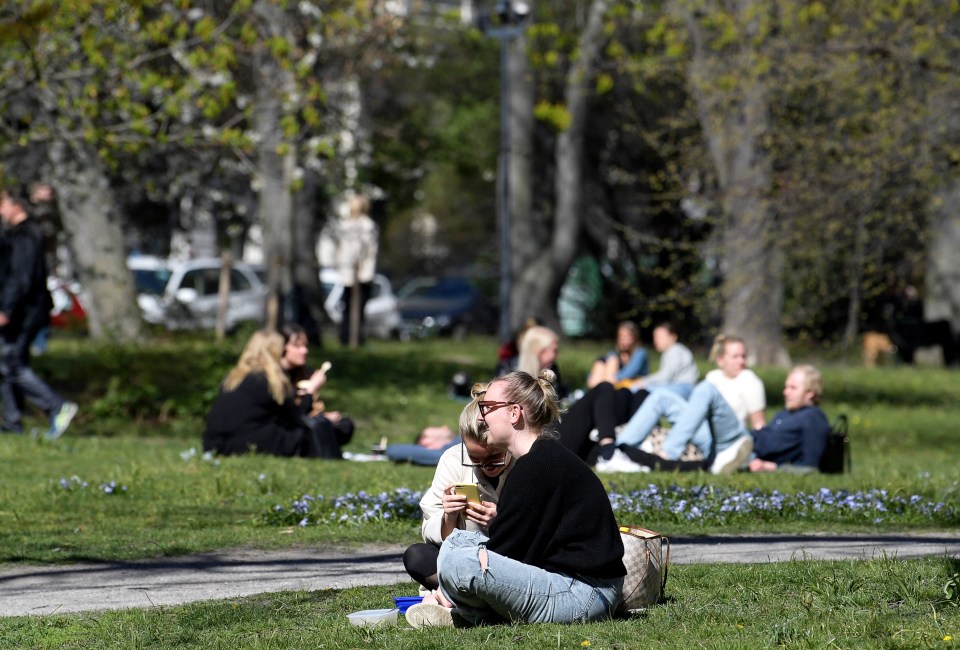  Locals gather at Humlegarden park in central Stockholm on Wednesday