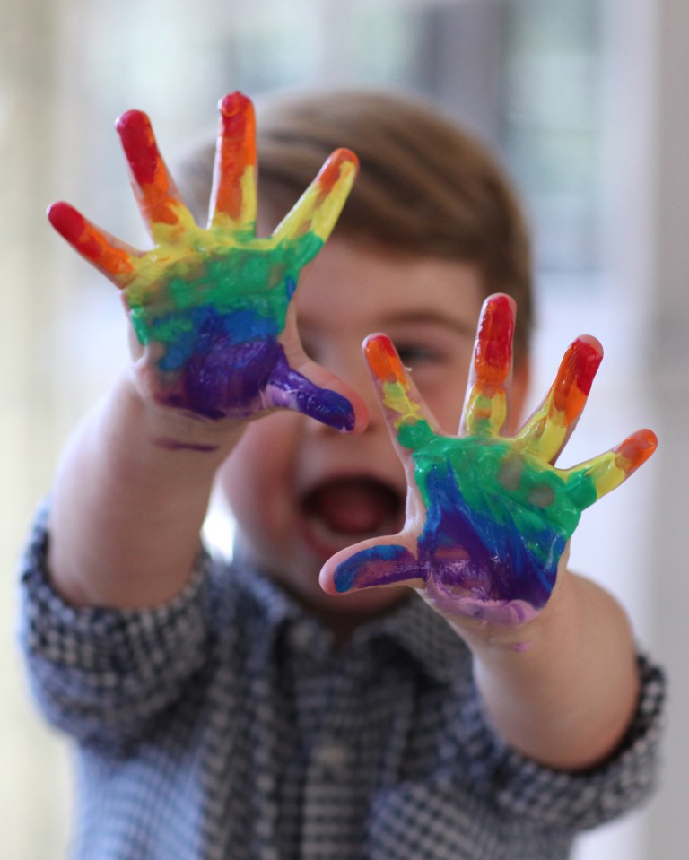  The toddler covered his hands in paint to create the poster