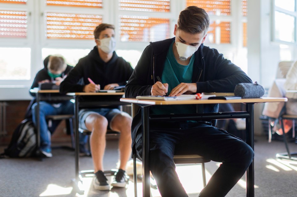  Pupils wear face masks and sit at spread-out individual desks after returning to school in Germany