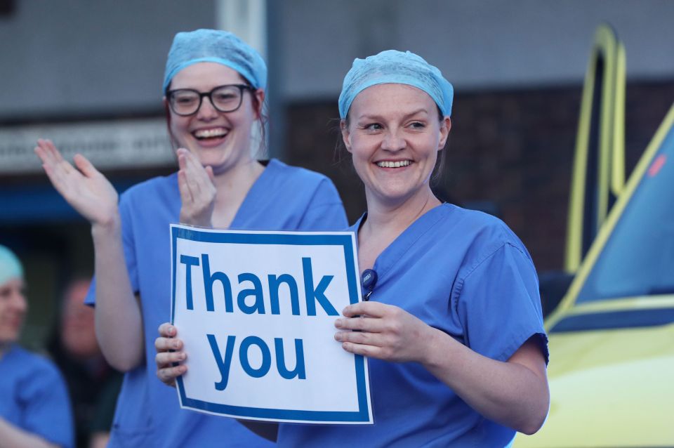  Staff hold a 'thank you' sign outside the William Harvey Hospital in Ashford, Kent