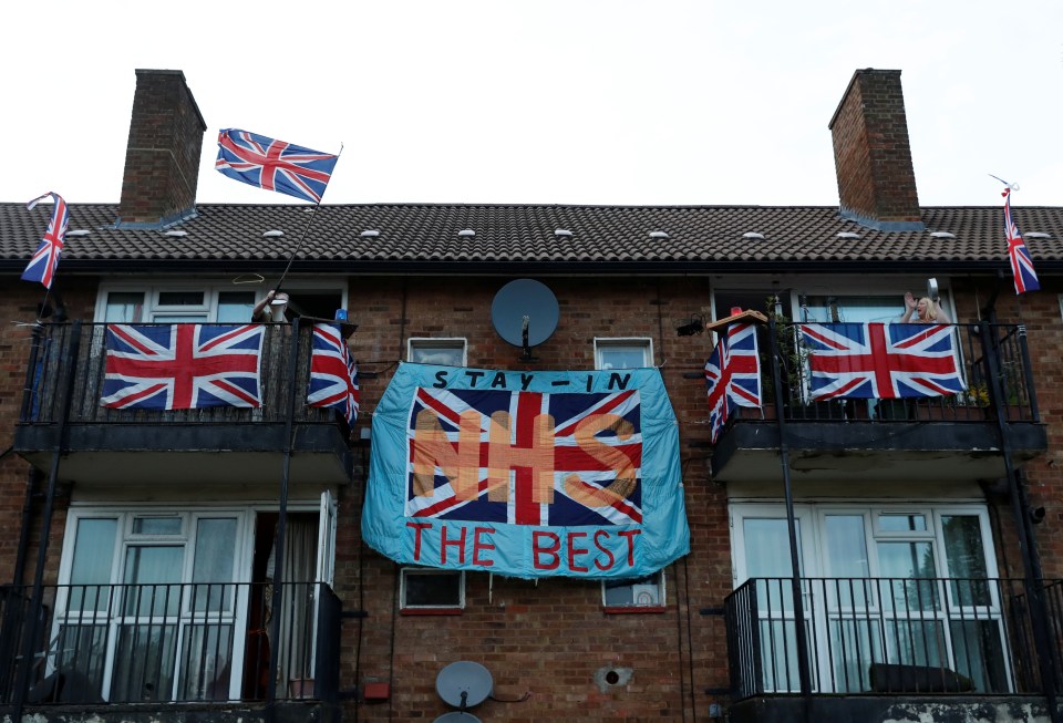  People in Hemel Hempstead, Hertfordshire, stand outside on their balconies and cheer