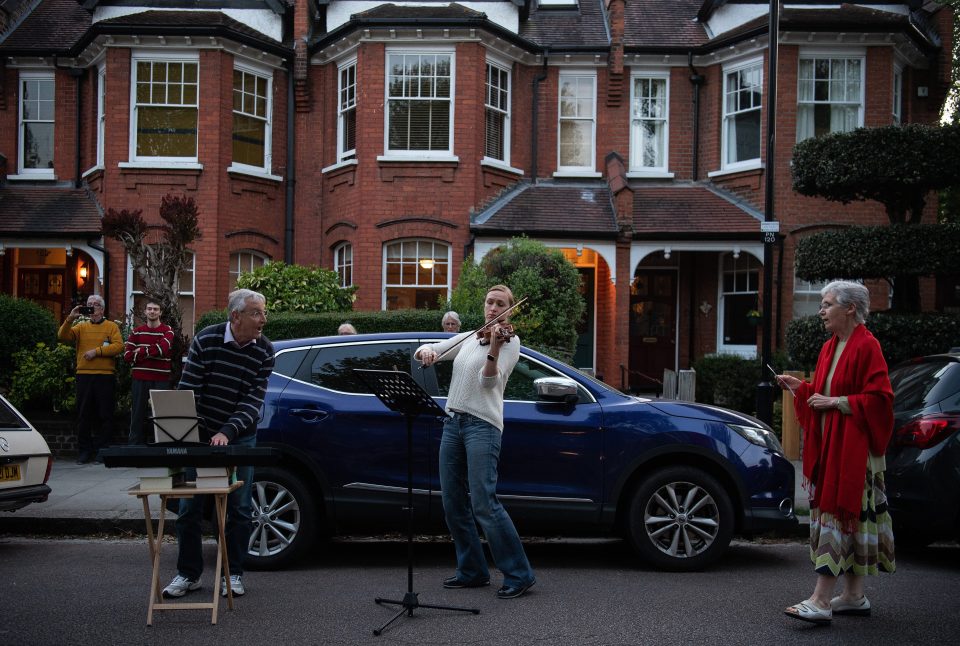  Musicians in Crouch End in London play instruments on the street to show appreciation