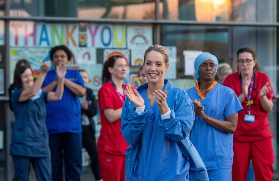  Overworked staff take a moment to stand outside Royal Derby Hospital and get some fresh air as they clap