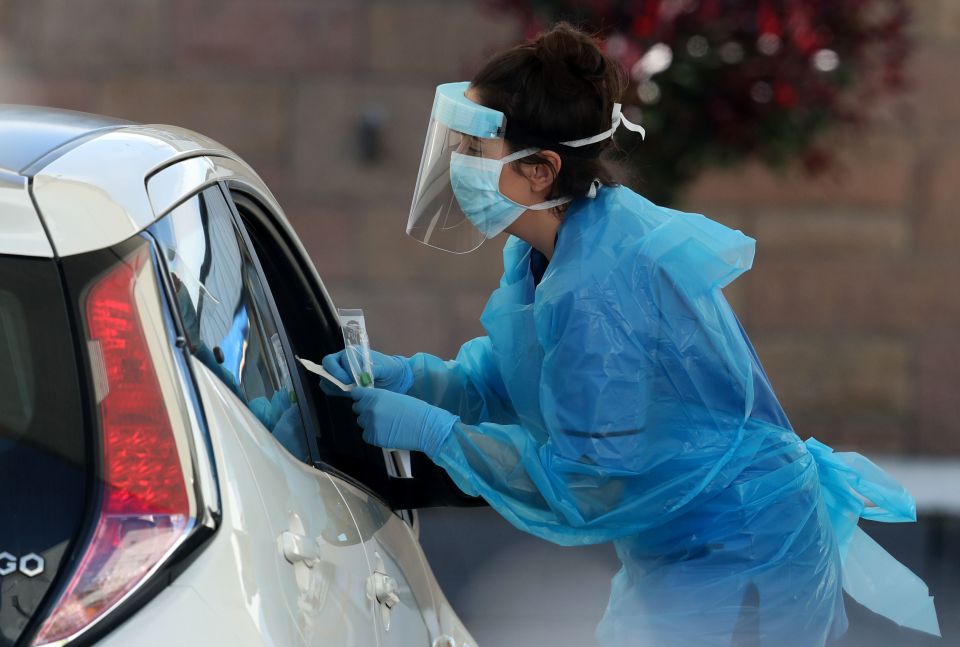  A nurse prepares to take a sample at a Covid-19 drive-through testing centre