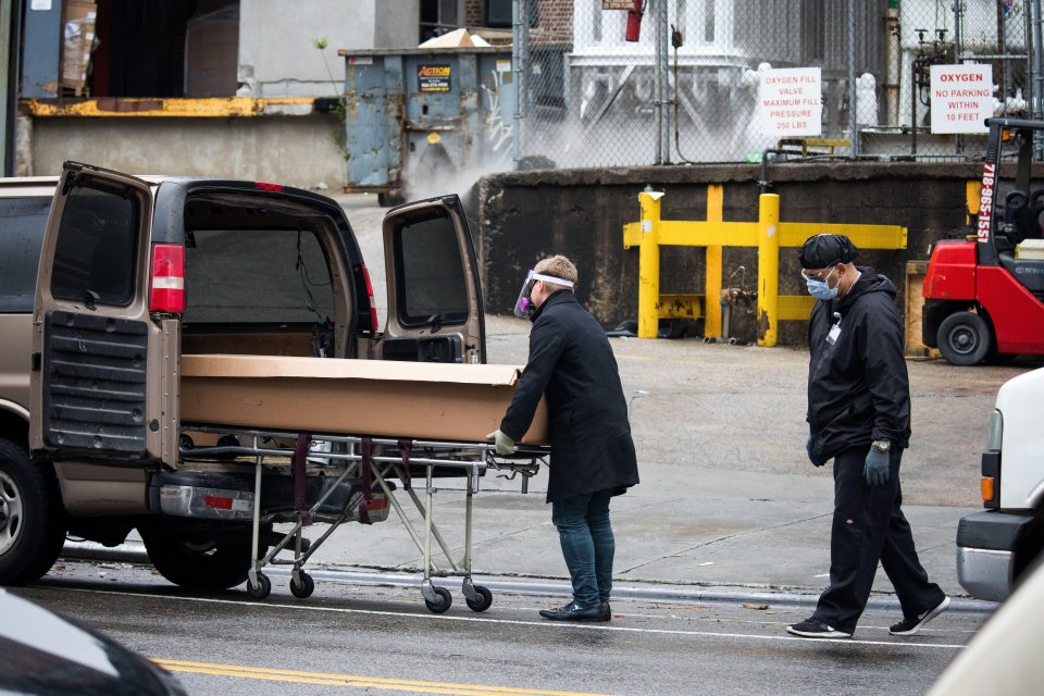  A funeral home worker wheels the body of a deceased person into a van outside Brooklyn Hospital Center in New York on April 24