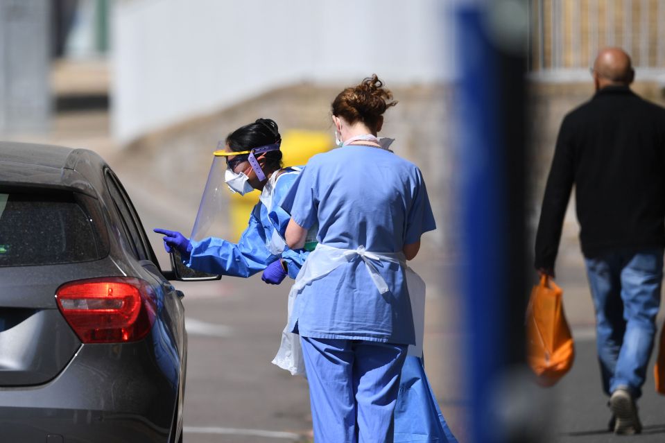  Medical workers at a drive-in testing facility in East London today