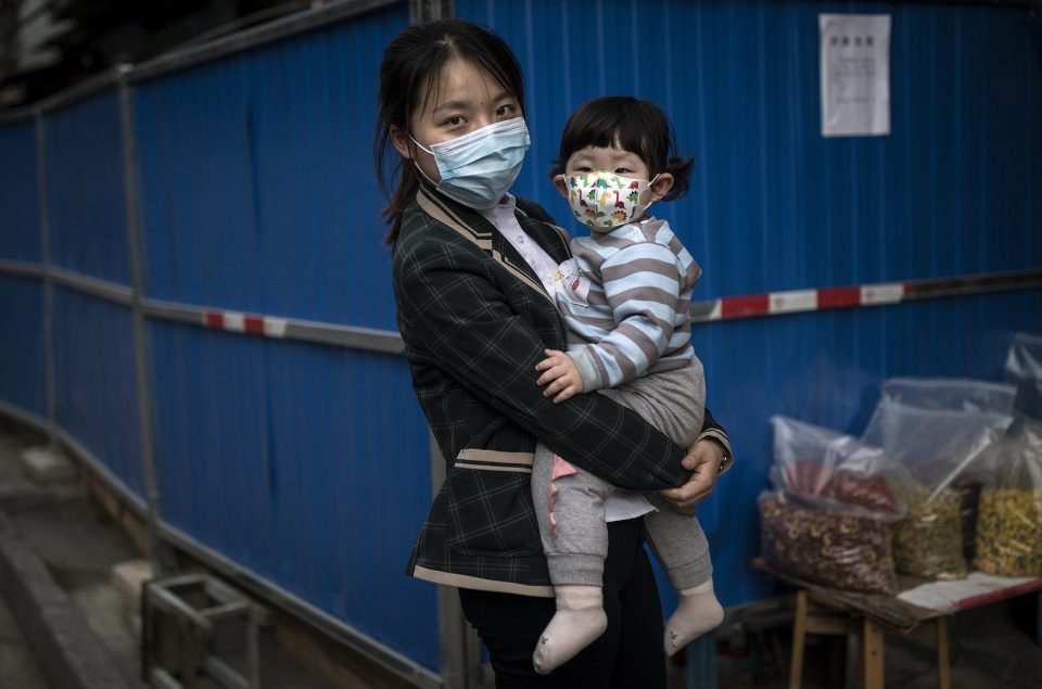  A woman queues up in Wuhan, after the government started lifting outbound travel restrictions