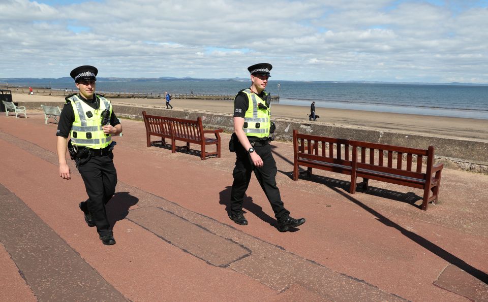  Police officers patrol the beach front at Portobello as the UK continues in lockdown