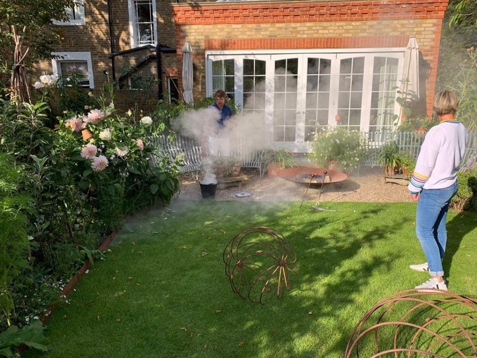 Ben takes control of the fire pit in their garden