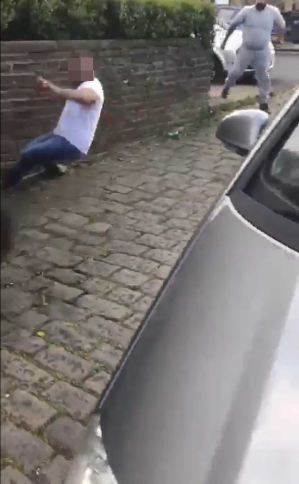 One man falls to the ground as the car pulls away