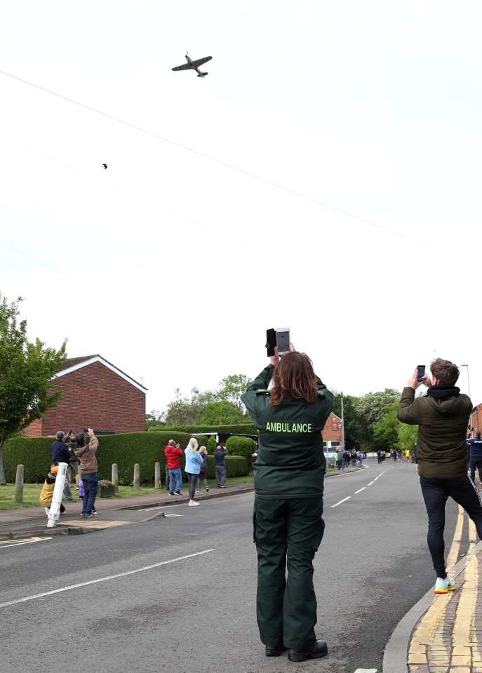  Locals stopped to film the flypast this morning