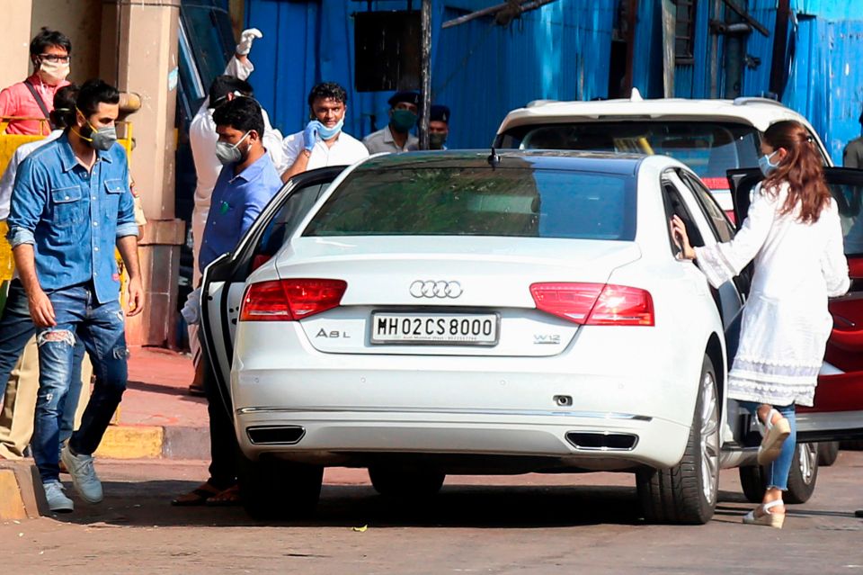  Ranbir Kapoor, left, and Alia Bhatt, right, leave after the service