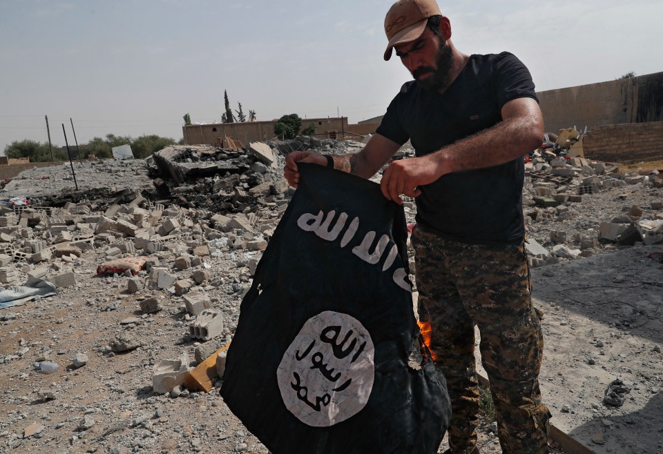  ISIS fighters are launching attacks and prison breaks in Syria and Iraq amid the coronavirus outbreak. Pictured a militant in Raqqa in 2017