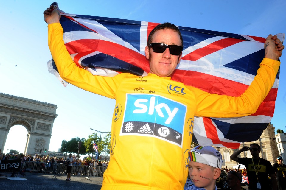 Bradley Wiggins celebrating his win in the Tour de France in 2012, wrapped in his national flag 