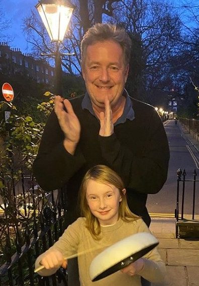  Piers applauding NHS workers with daughter Elise, 8, in the weekly Clap for Carers