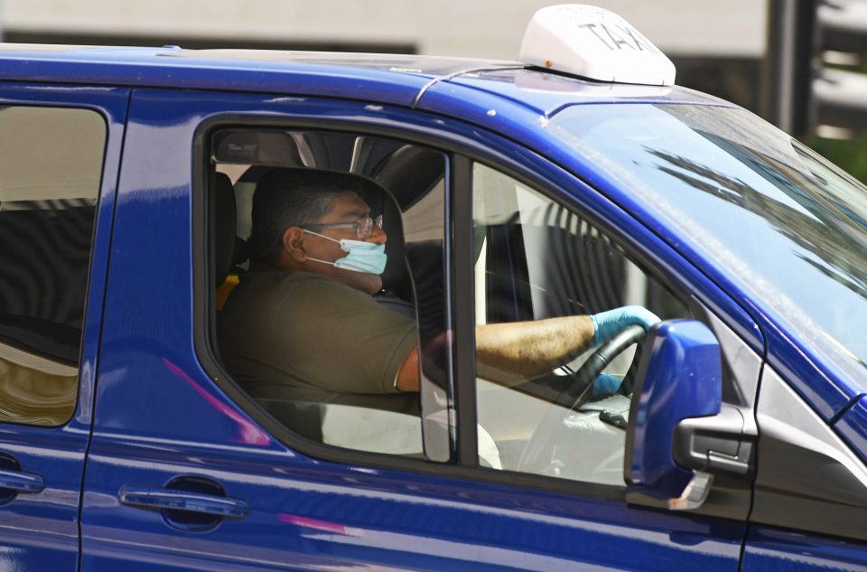  A cabbie wears a face mask to protect himself from coronavirus in Bristol