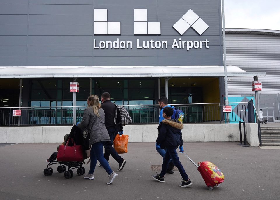  A family walks into Luton Airport as they take one of the first flights out of the country with Wizz Air