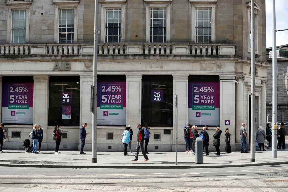 People queue outside an AIB Bank in Dublin City Centre amid the coronavirus pandemic