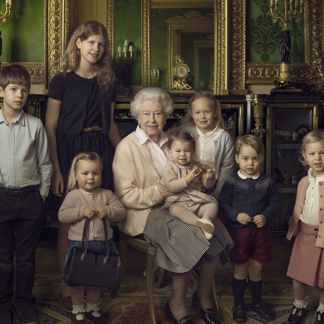 In the past, people have also pointed out how similar Charlotte looks to the Queen. Pictured here sitting on her great-grandma's lap