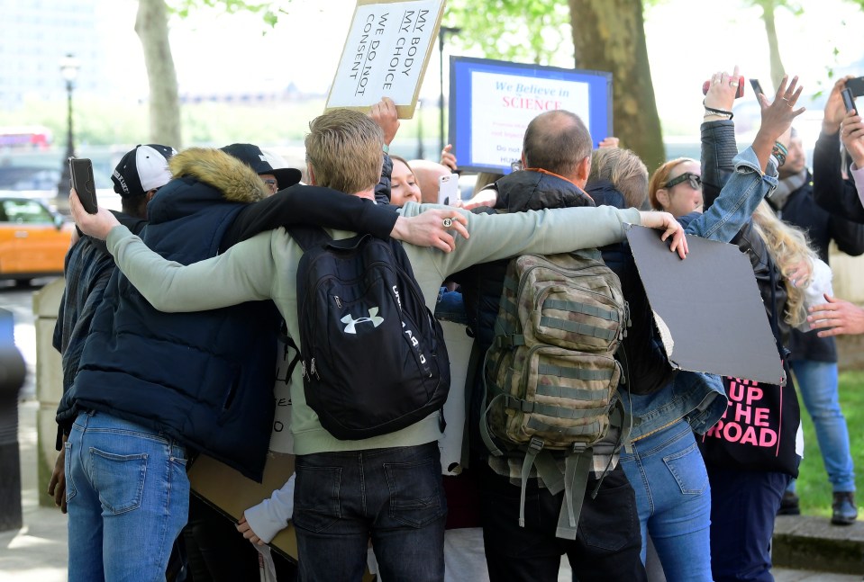  Protesters staged a huge group hug outside London police HQ