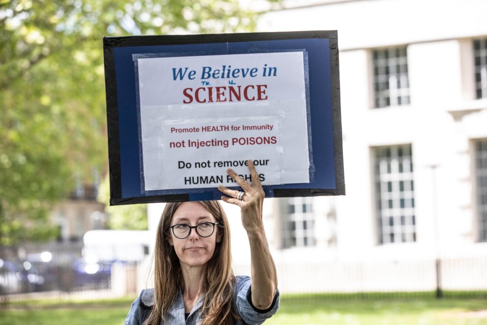  A woman holds up a sign against vaccines