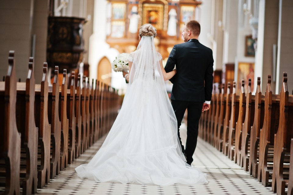  A bride and groom walk down the isle on their wedding day