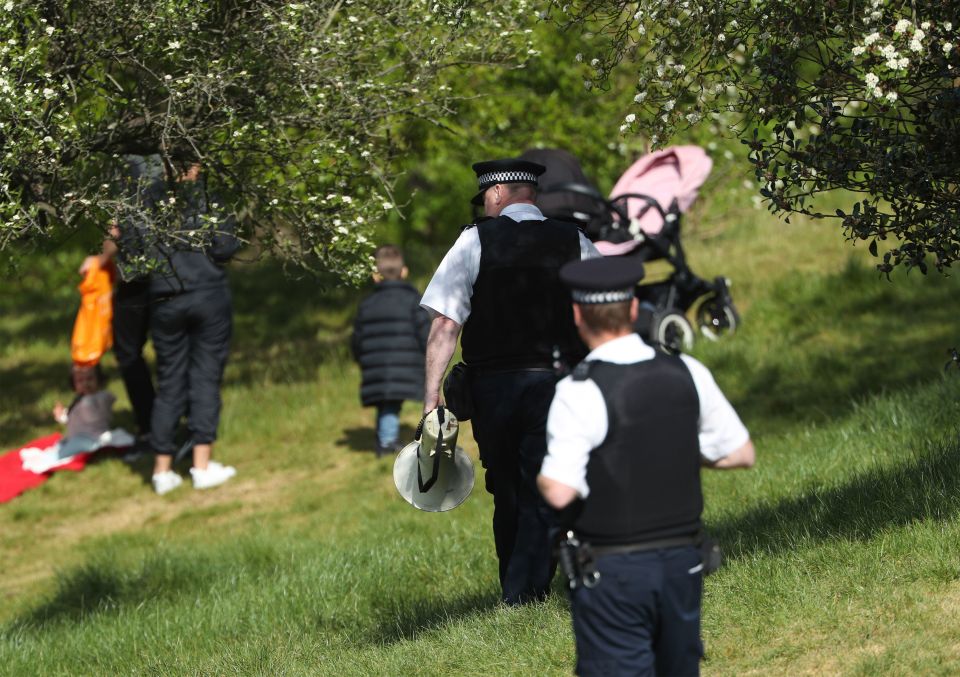  Cops with a megaphone tell people to keep moving in Greenwich Park