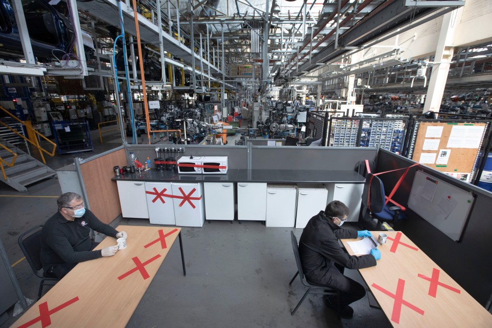 Vauxhall car plant staff keep their distance during a break