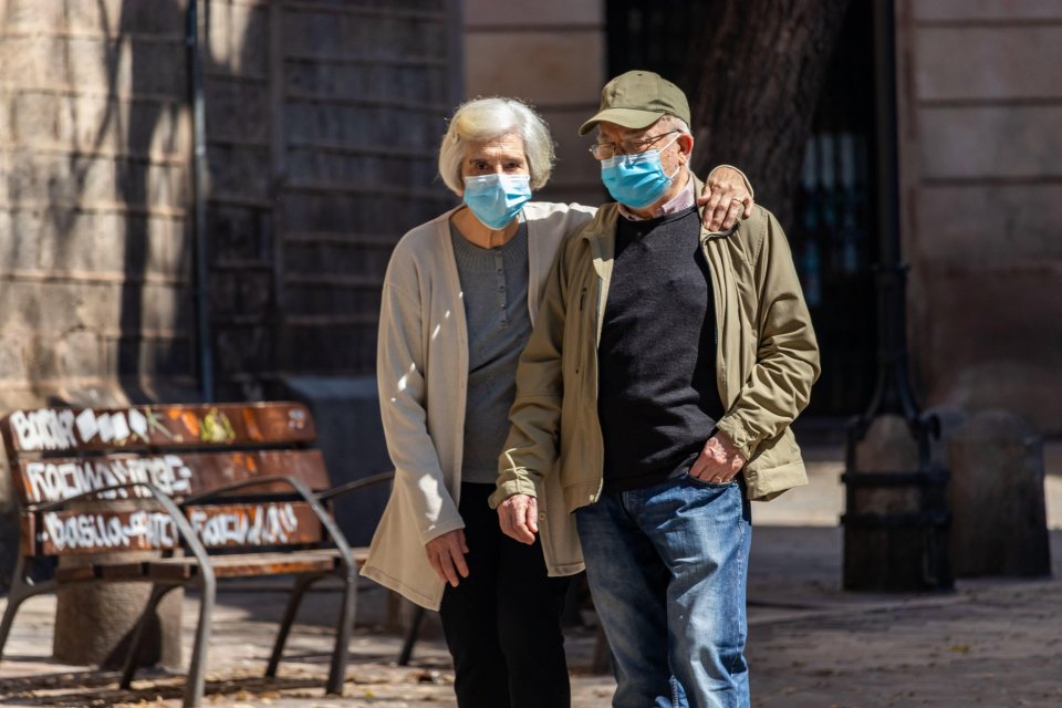  A couple stroll through central Barcelona during the hours where senior people are allowed to go outdoors