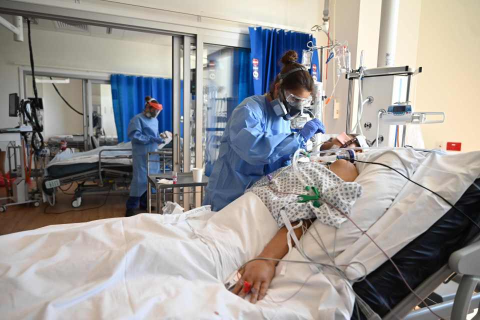  An NHS worker cares for a patient on the intensive care unit at Royal Papworth Hospital in Cambridge