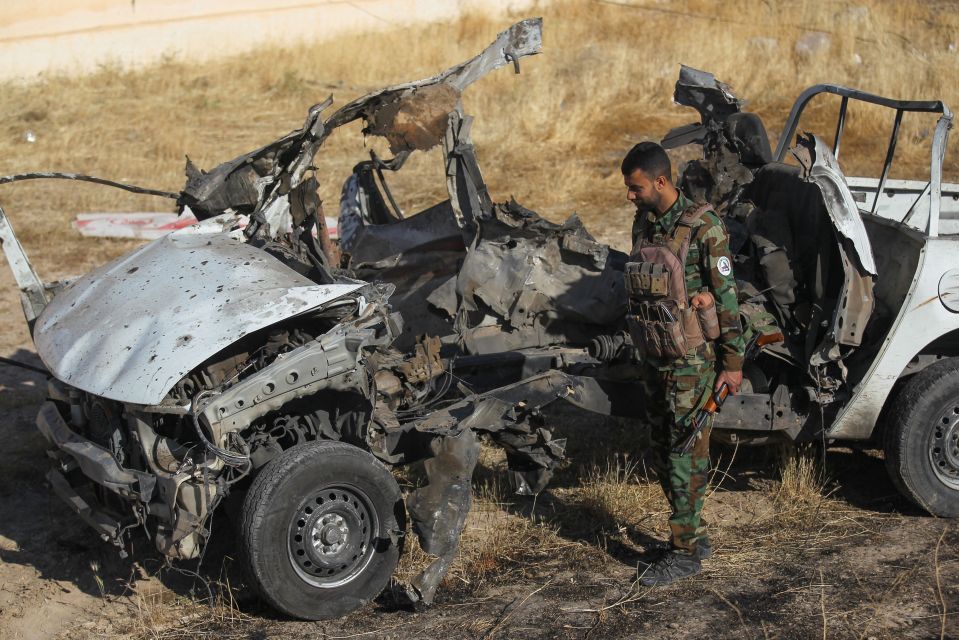  An Iraqi fighter inspects the site of an ISIS attack in Mukaishefah, north of Baghdad