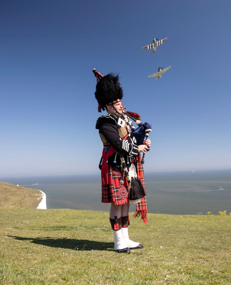  Major Andy Reid of The Scots Guards plays his pipes on the cliffs of Dover, Kent, as two Spitfires from the Battle of Britain memorial flight fly overhead