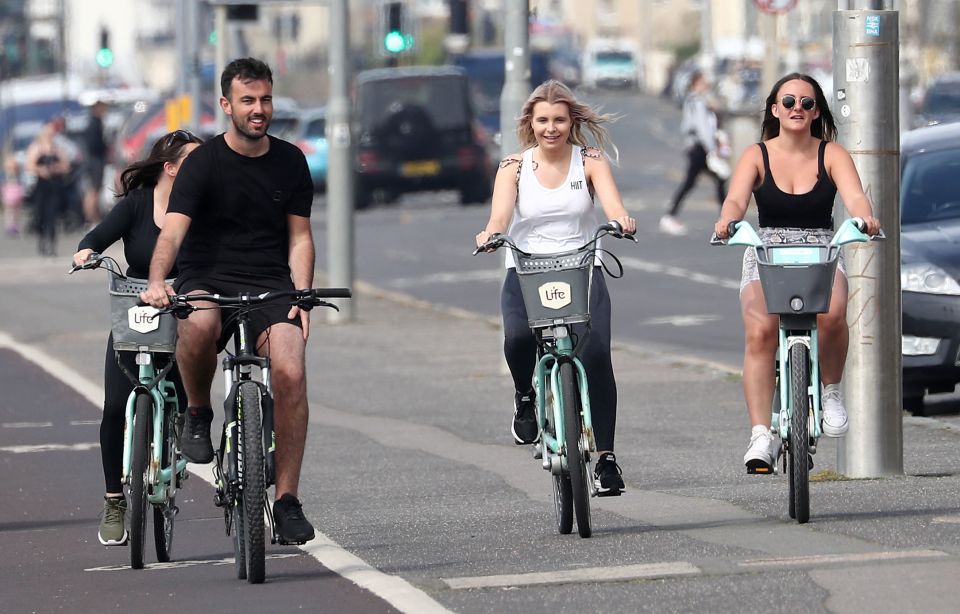  People cycle along the promenade during the warm weather in Brighton today