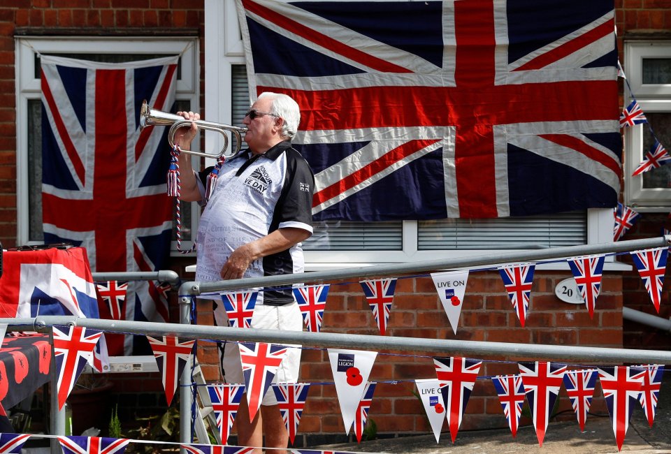  Mick Wells plays the Last Post outside his home in Leicestershire before the start of two minutes silence