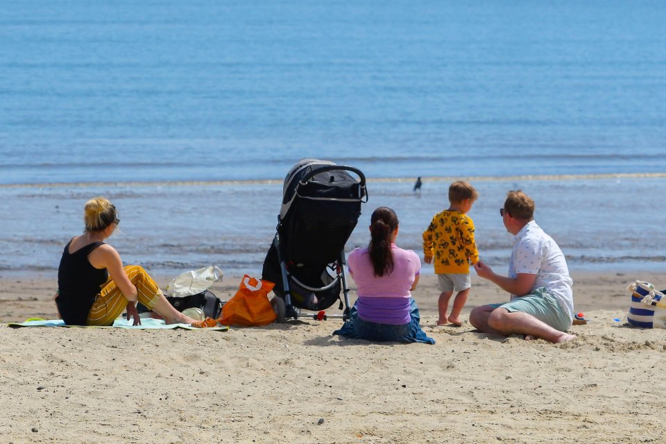  A family enjoyed the sunshine on Weymouth beach today