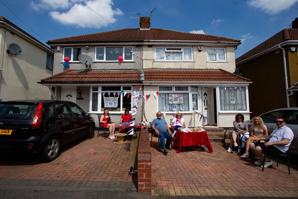  Families sit outside their homes in Bristol to celebrate VE Day