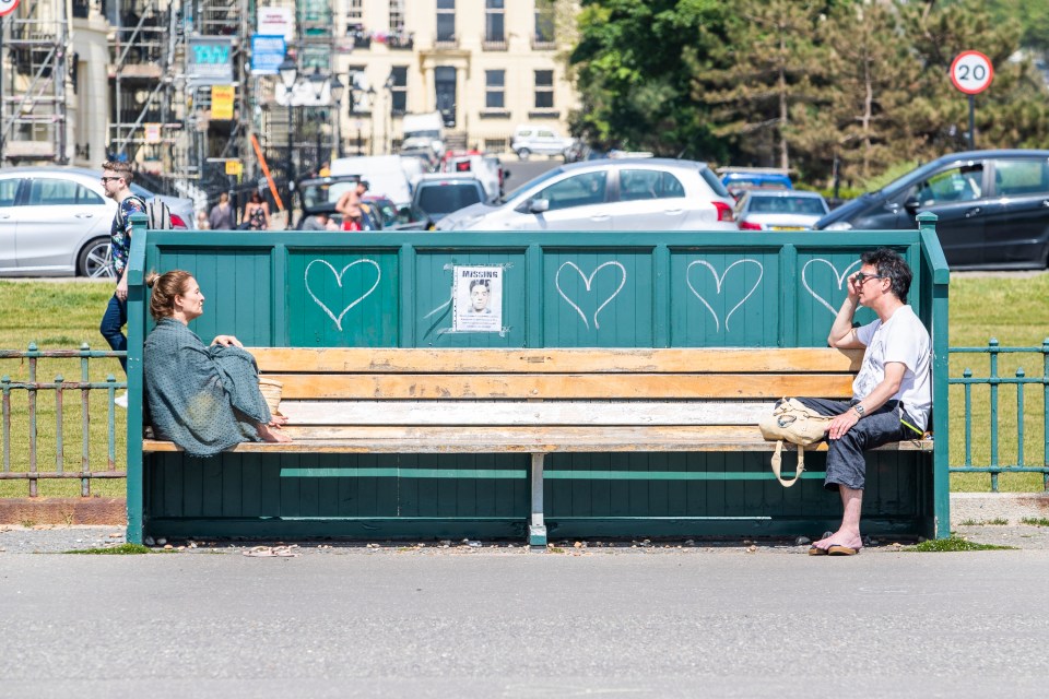  Two friends observe social distancing in Brighton earlier today