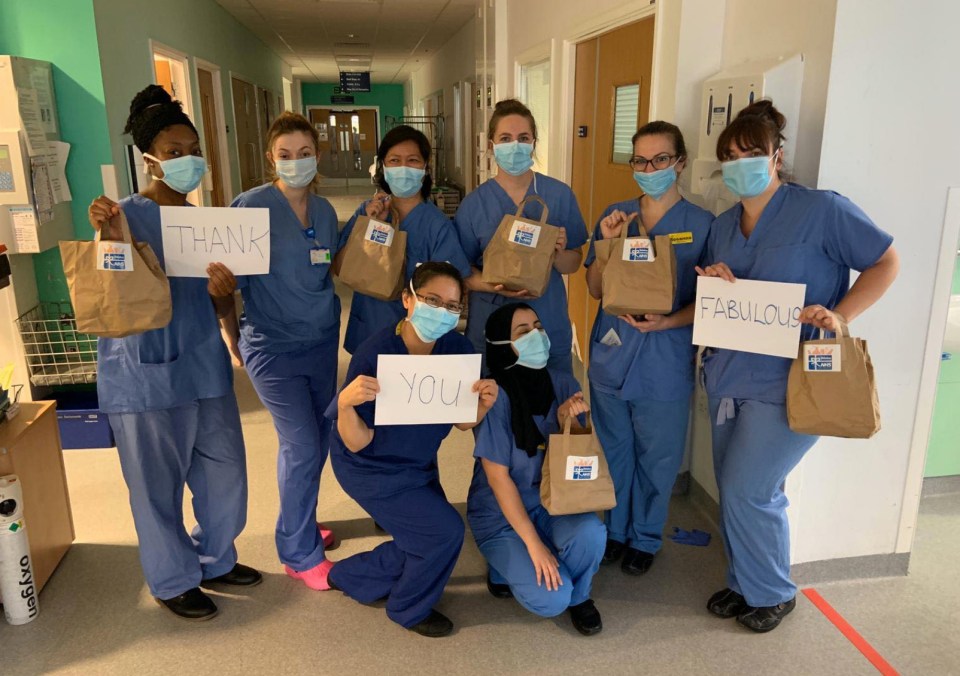 Health workers at the Queen Elizabeth Hospital in Birmingham hold up ‘thank you’ signs