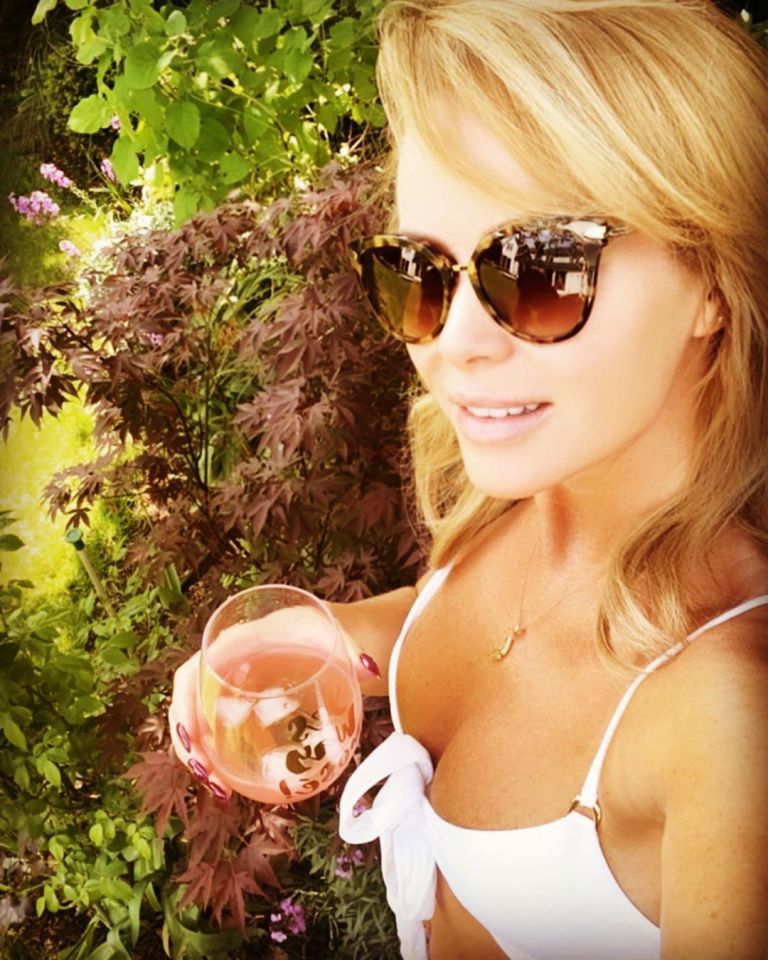  Britain's Got Talent's Amanda Holden showed off her cleavage in a white bikini as she enjoyed a glass of wine in her garden during lockdown