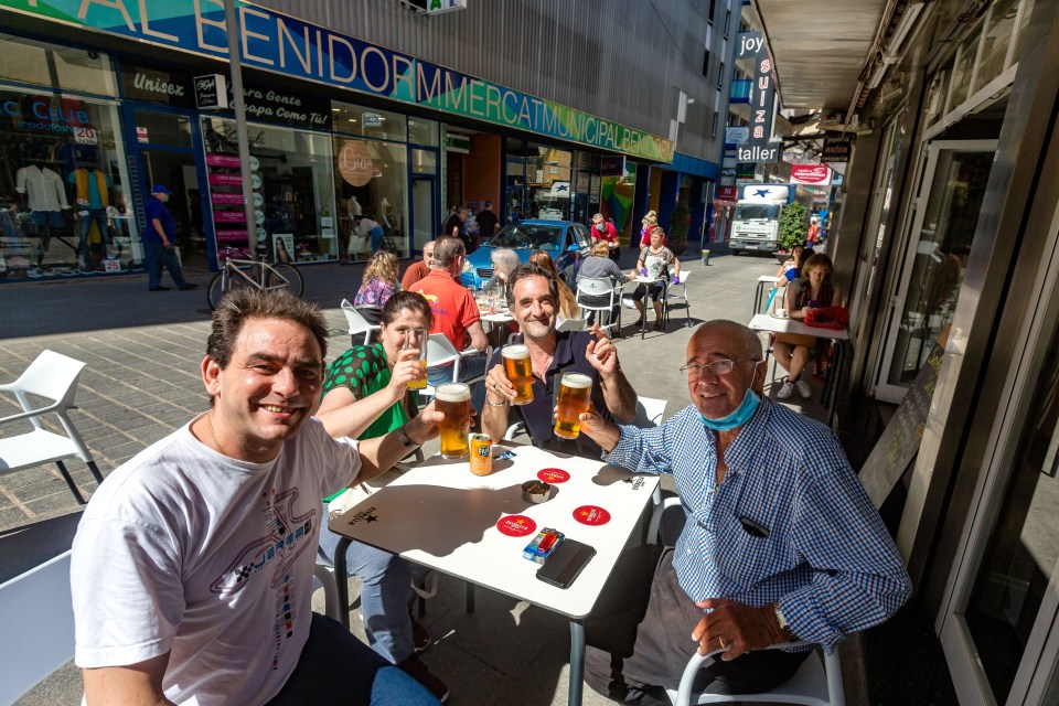  A happy group knock back their first pub pints since March