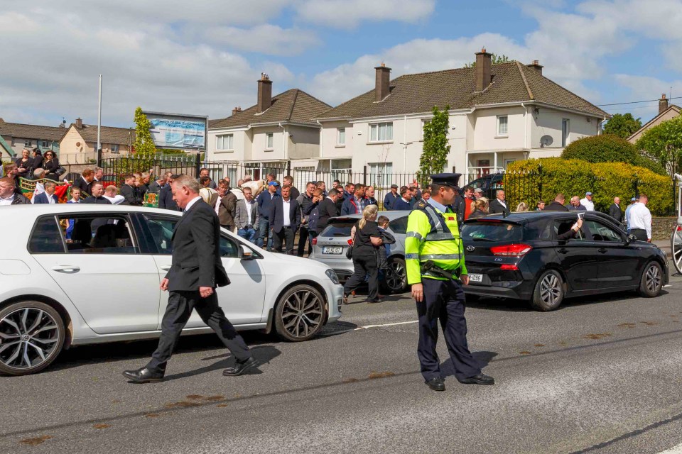  An officer watches on as large crowds gathered outside the Cork church