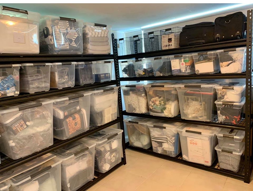 Her utlity cupboard has boxes stored with household supplies and overflow items