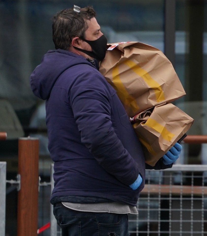 A delivery driver carrying orders outside a restaurant in Essex last week